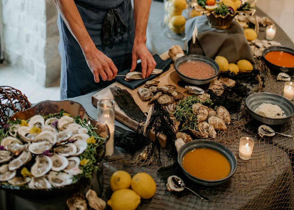Chef plating oysters in the Irvine Cocktail Reception